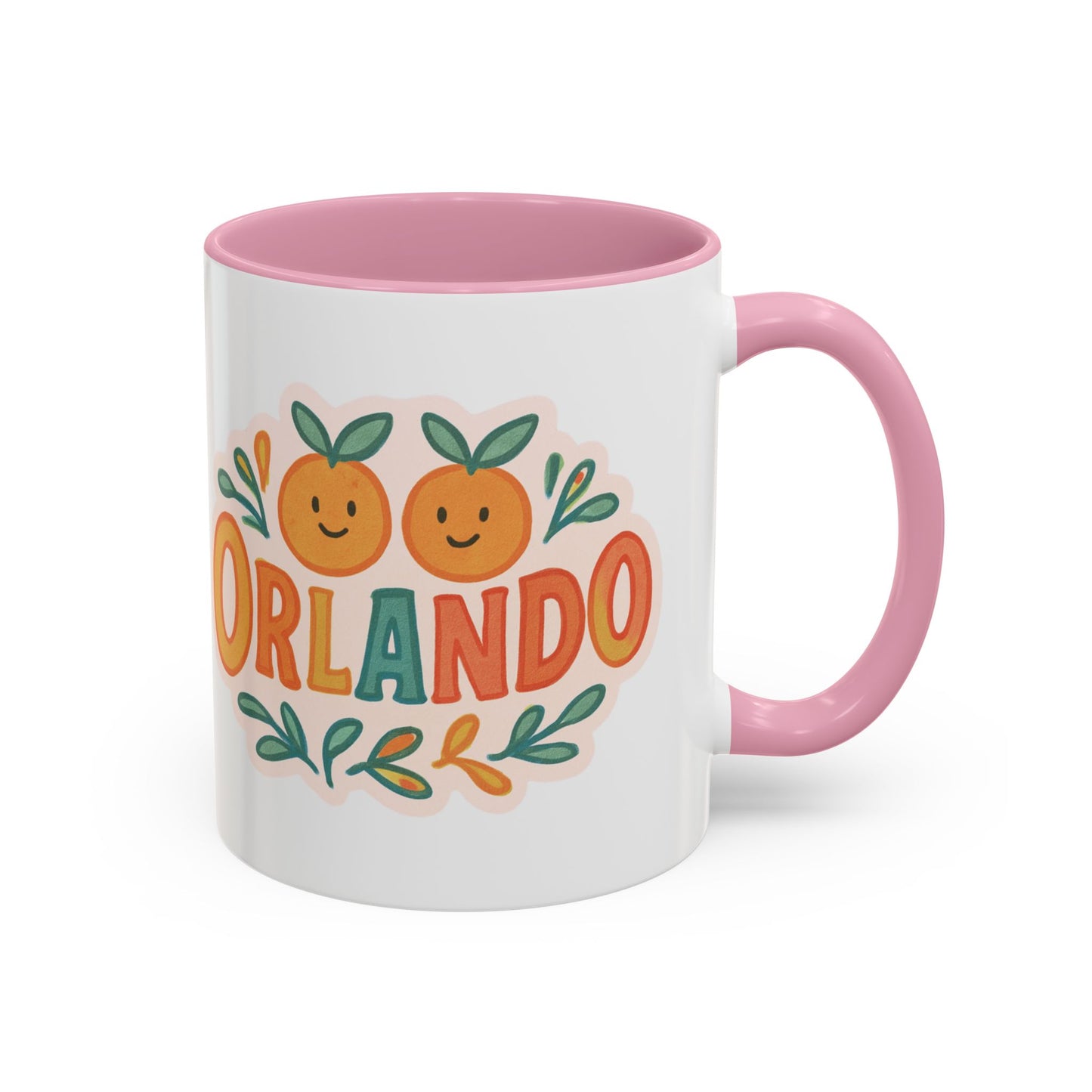white ceramic mug with 'Orlando' written in orange lettering, accompanied by a graphic of orange and green leaves. The mug has a pink interior and handle.