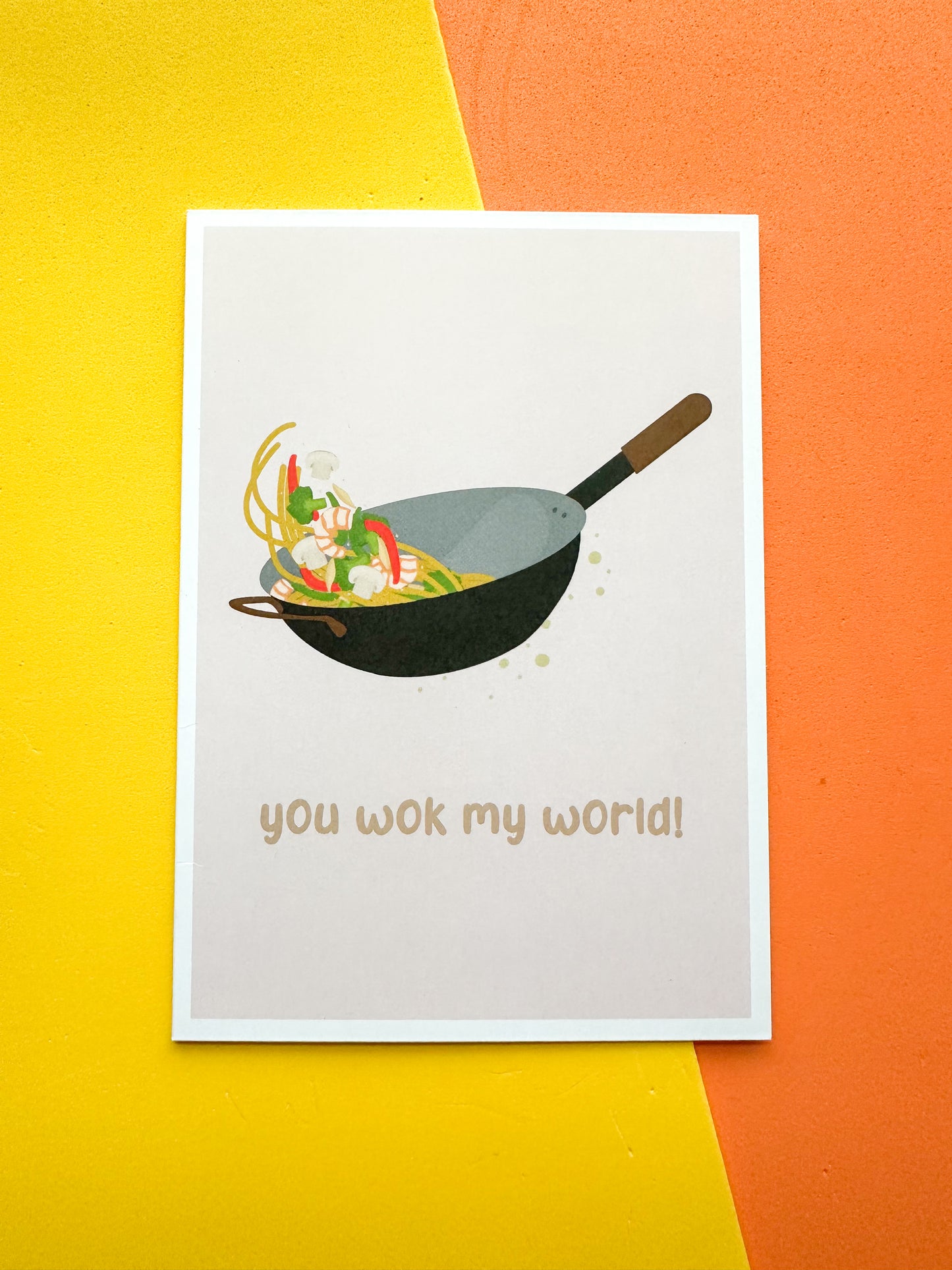 Greeting card with an illustration of a wok and the phrase 'you wok my world'