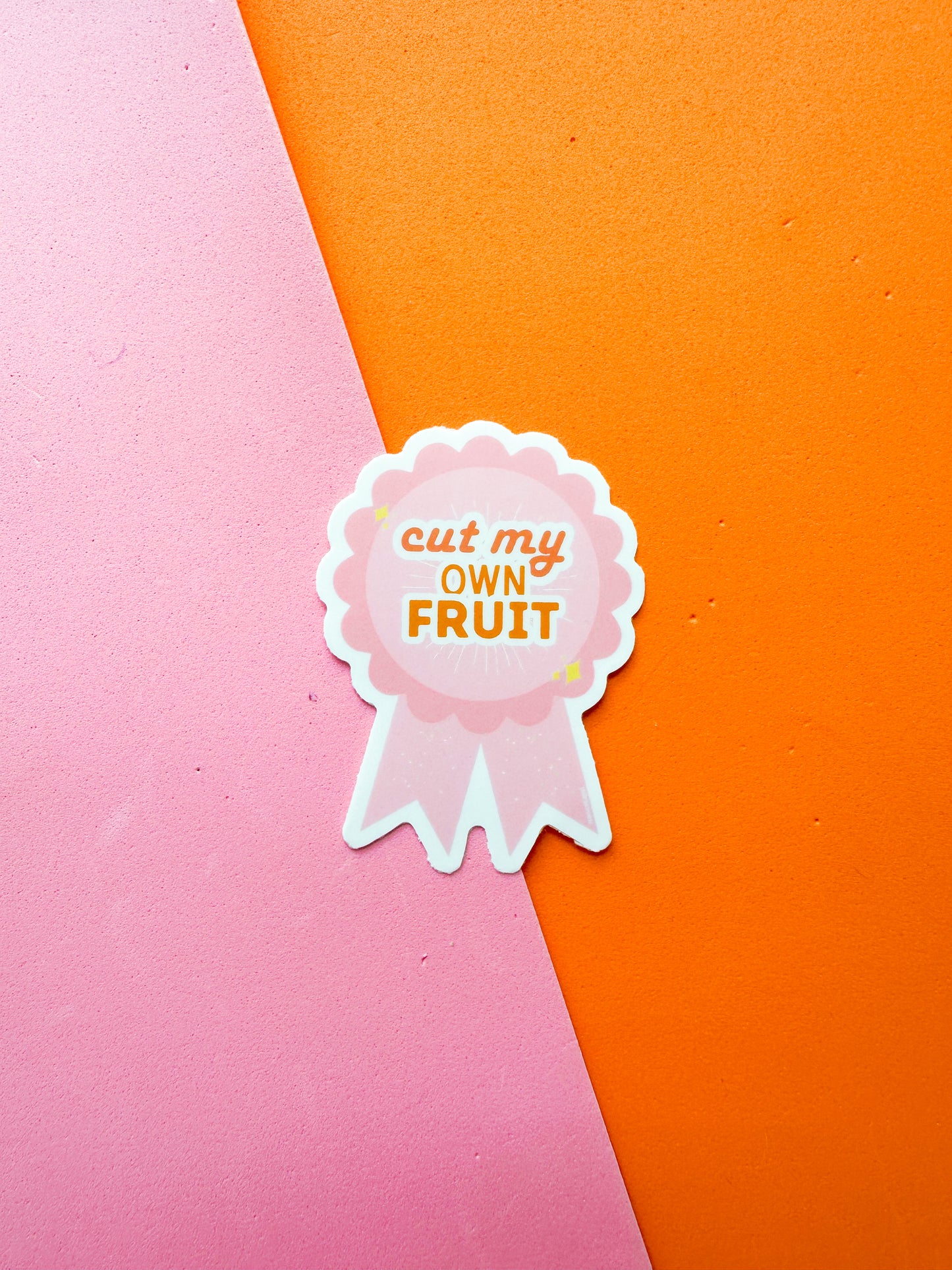 Sticker with 'cut my own fruit' text on a ribbon