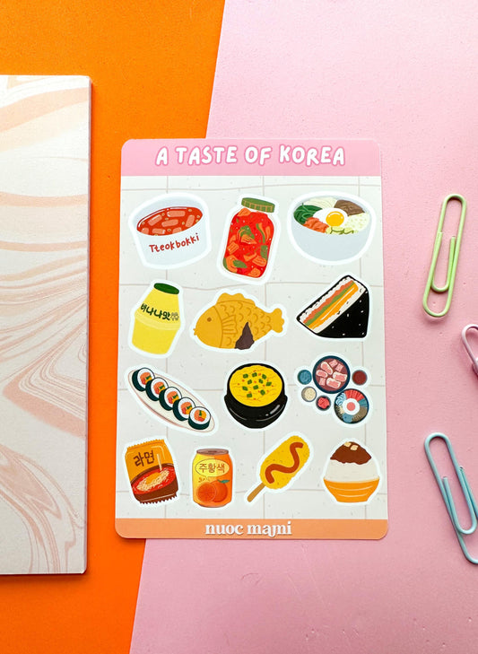 A sticker sheet titled 'A Taste of Korea' featuring various Korean food icons 