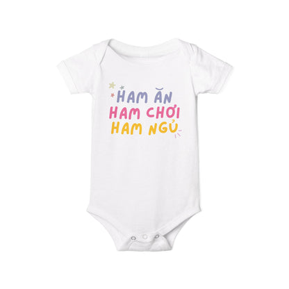 White baby onesie with colorful text Ham An Ham Choi Ham Ngu