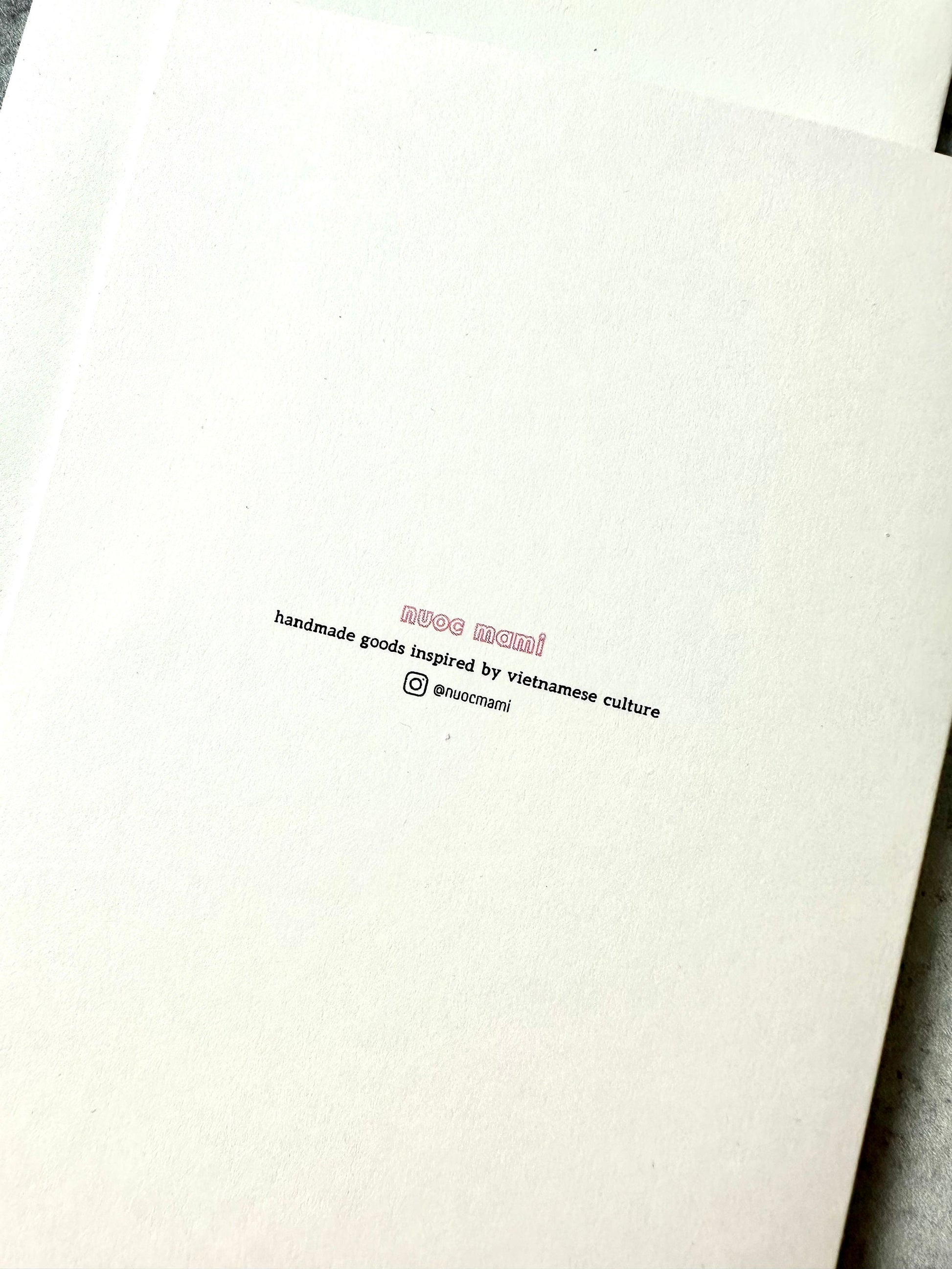 greeting card back with text nuoc mami handmade goods inspired by vietnamese culture with instagram handle @nuocmami