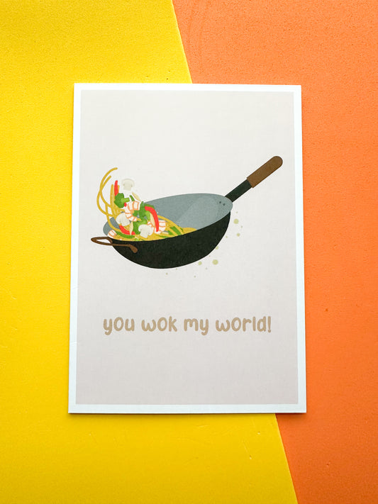 Greeting card with an illustration of a wok and the phrase 'you wok my world' 
