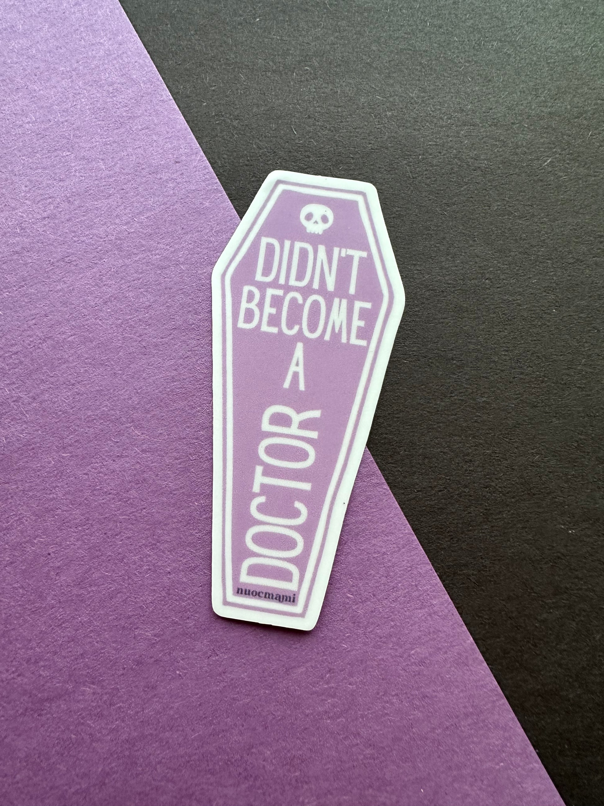 Coffin-shaped sticker with text 'Didn't become a doctor' 