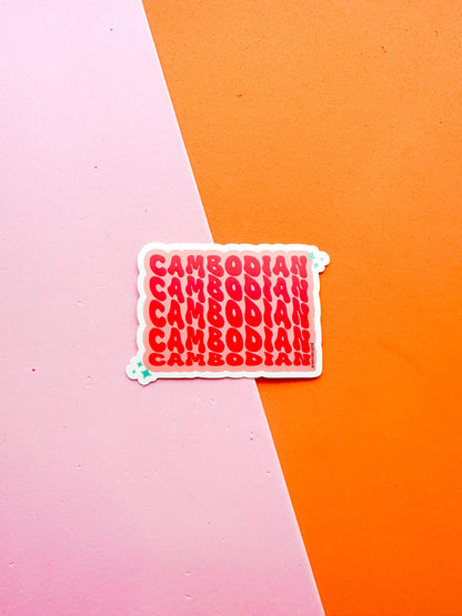 A matte premium vinyl sticker with the word 'CAMBODIA' in bold red letters on a pink background 
