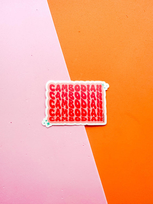 A matte premium vinyl sticker with the word 'CAMBODIA' in bold red letters on a pink background 