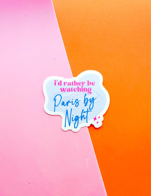 A matte premium vinyl sticker with the phrase 'I'd Rather be Watching Paris by Night'  