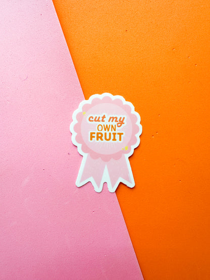 Sticker with 'cut my own fruit' text on a ribbon
