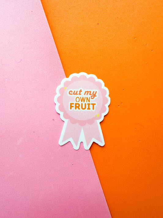 Sticker with 'cut my own fruit' text on a ribbon