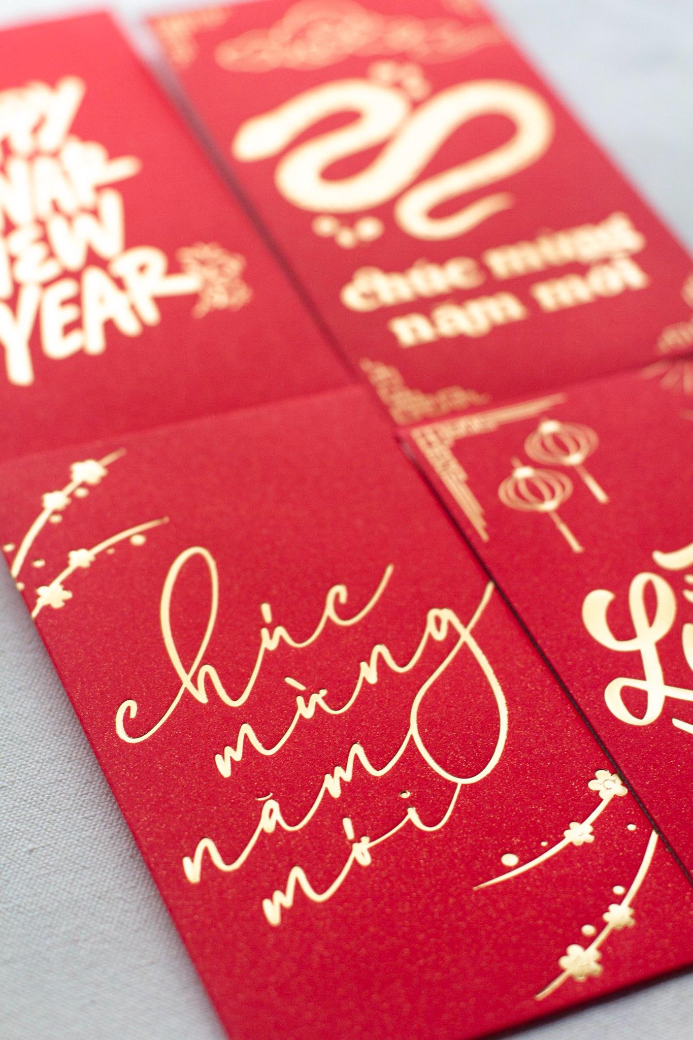 A vibrant red envelope with gold foil accents and text that translates to 'May you be prosperous this new year' in Vietnamese.

Lunar New Year Envelopes, Vietnamese Lucky Red Envelopes, Bao Li Xi, Hongbao, Chuc Mung Nam Moi Envelopes, Lunar New Year Tet 2025 Envelopes