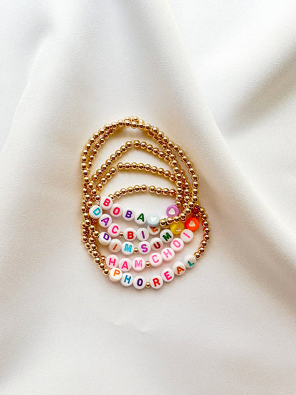 A gold-filled beaded bracelets with famous and iconic words