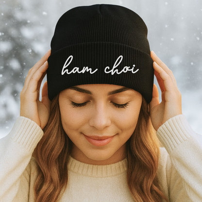 Woman wearing a black beanie with 'han choi' text against a snowy background